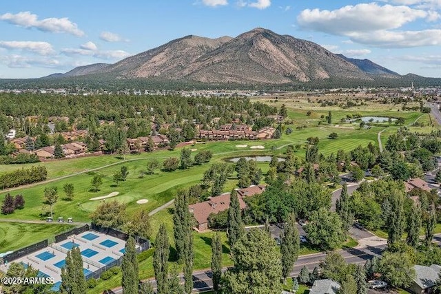 aerial view with view of golf course and a mountain view