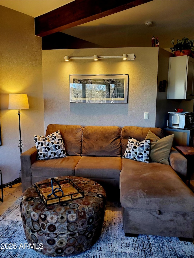 tiled living room featuring beam ceiling