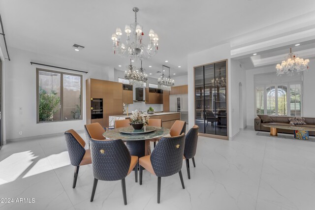 dining room featuring a notable chandelier and plenty of natural light