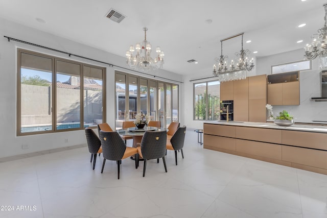 dining area featuring a chandelier and sink