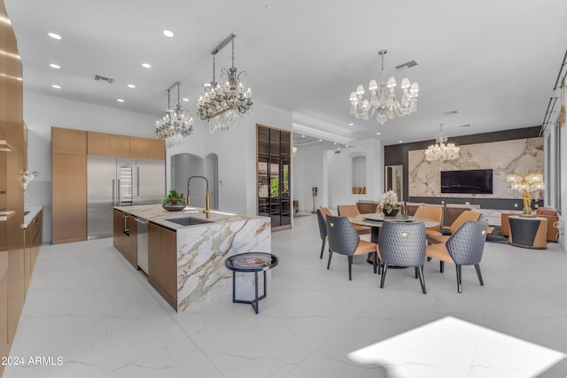 kitchen featuring dishwasher, sink, hanging light fixtures, and a large island