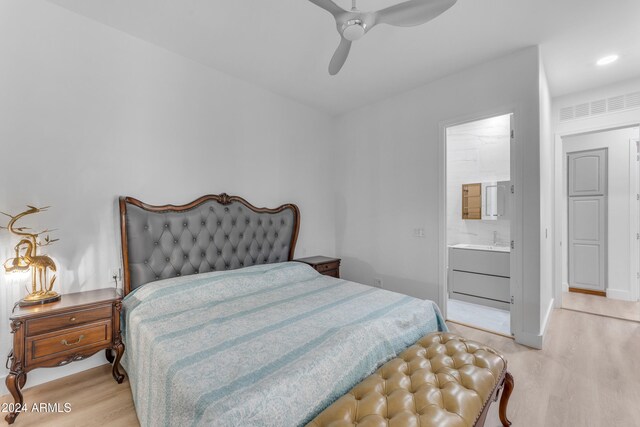 bedroom featuring light wood-type flooring, ceiling fan, and ensuite bathroom