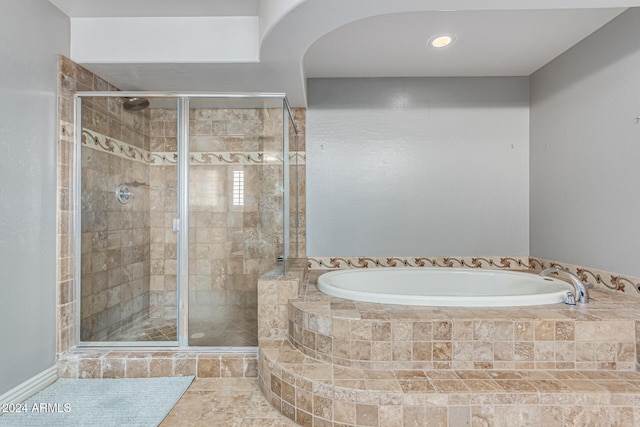 bathroom with tile patterned floors and separate shower and tub