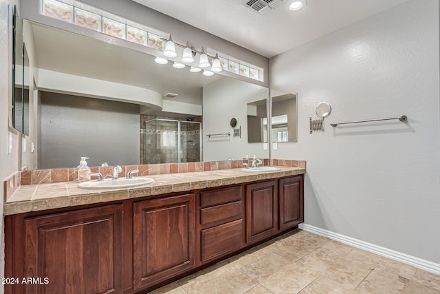 bathroom with vanity, tile patterned floors, and walk in shower