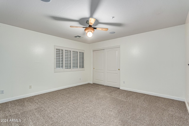 interior space featuring ceiling fan and carpet floors