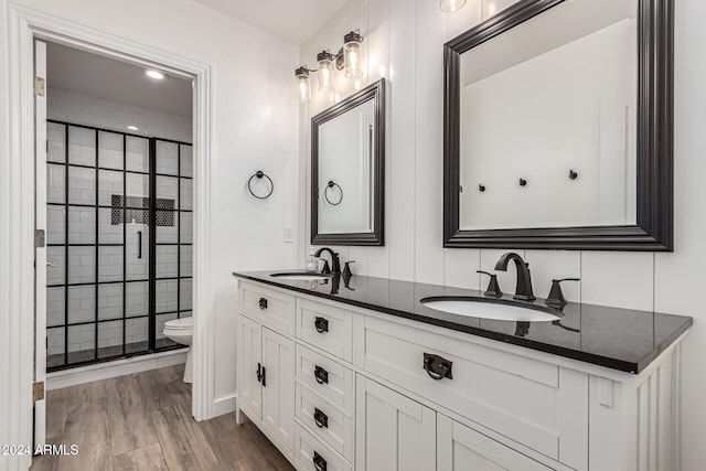 bathroom with vanity, wood-type flooring, toilet, and walk in shower