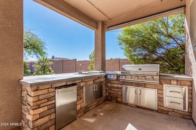 view of patio featuring an outdoor kitchen, sink, and a grill