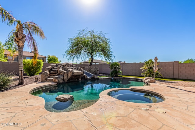 view of pool with an in ground hot tub and a patio