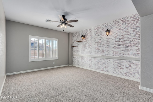 spare room with ceiling fan and carpet