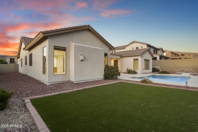 3551 W Hidden Mountain Ln, Anthem, AZ 85086 - rear view of house with a fenced backyard, stucco siding, and a tiled roof