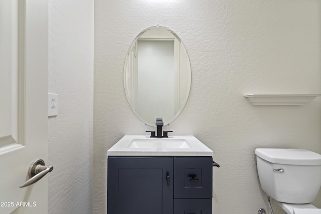 3551 W Hidden Mountain Ln, Anthem, AZ 85086 - half bathroom featuring vanity, a textured wall, and toilet