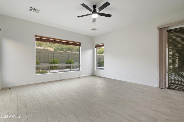 3551 W Hidden Mountain Ln, Anthem, AZ 85086 - unfurnished room featuring baseboards, ceiling fan, visible vents, and wood finished floors