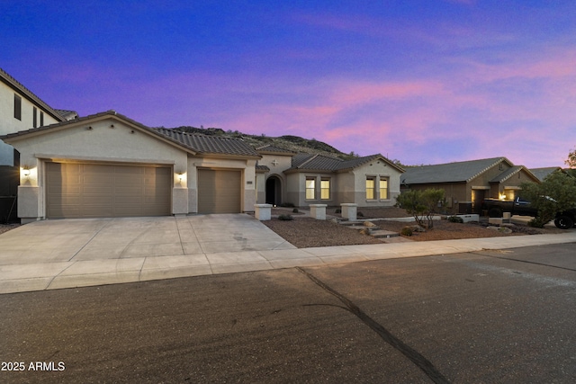 3551 W Hidden Mountain Ln, Anthem, AZ 85086 - view of front of house featuring driveway, stucco siding, a tiled roof, and an attached garage
