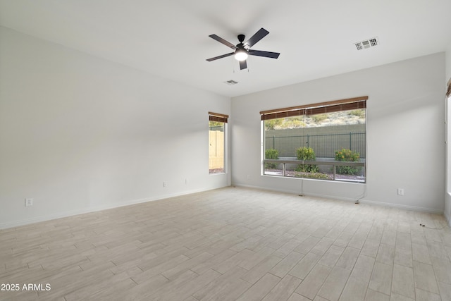 3551 W Hidden Mountain Ln, Anthem, AZ 85086 - spare room with light wood-type flooring, baseboards, visible vents, and a ceiling fan