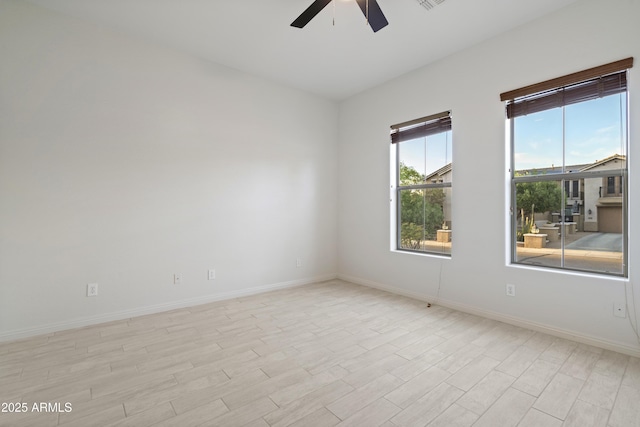 3551 W Hidden Mountain Ln, Anthem, AZ 85086 - spare room featuring light wood-style floors, baseboards, and ceiling fan