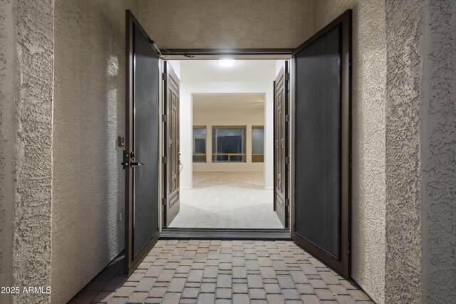 3551 W Hidden Mountain Ln, Anthem, AZ 85086 - hall with a textured wall and brick floor
