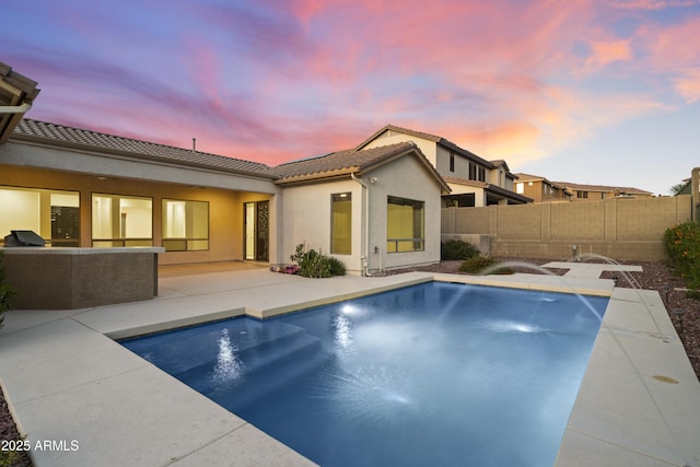 3551 W Hidden Mountain Ln, Anthem, AZ 85086 - rear view of house featuring a fenced in pool, a patio area, stucco siding, a tile roof, and a fenced backyard