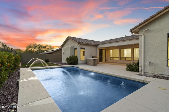 3551 W Hidden Mountain Ln, Anthem, AZ 85086 - back of property with a tiled roof, a fenced in pool, a patio, stucco siding, and a fenced backyard