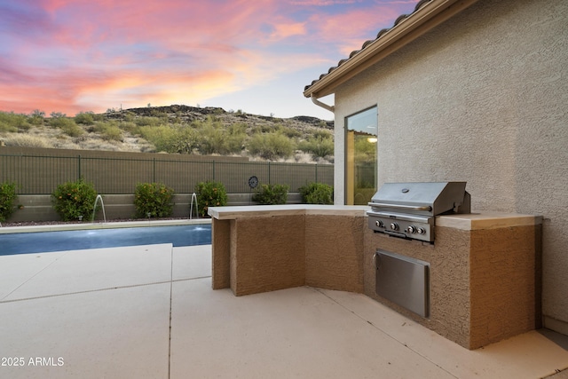3551 W Hidden Mountain Ln, Anthem, AZ 85086 - view of swimming pool with a patio, an outdoor kitchen, a fenced backyard, and grilling area