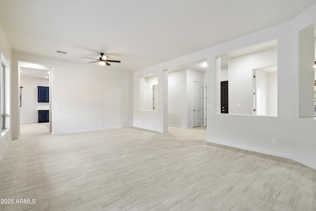 3551 W Hidden Mountain Ln, Anthem, AZ 85086 - unfurnished living room featuring baseboards, ceiling fan, light wood finished floors, and visible vents