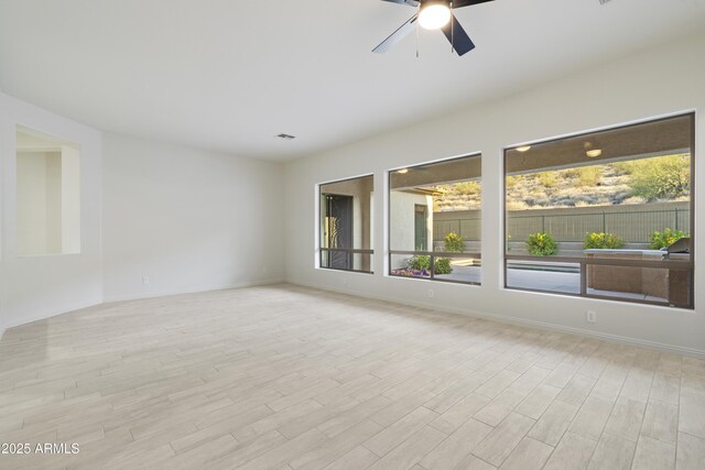 3551 W Hidden Mountain Ln, Anthem, AZ 85086 - unfurnished room with baseboards, a ceiling fan, and wood finished floors