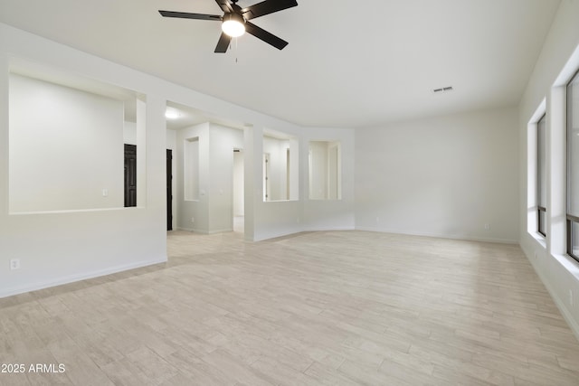 3551 W Hidden Mountain Ln, Anthem, AZ 85086 - empty room with a ceiling fan, baseboards, visible vents, and light wood-style flooring