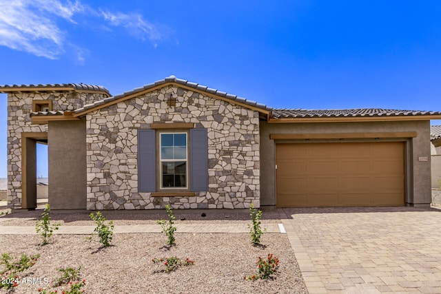 20755 W San Miguel Ave, Buckeye, AZ 85396 - view of front of property featuring a tiled roof, decorative driveway, a garage, and stucco siding