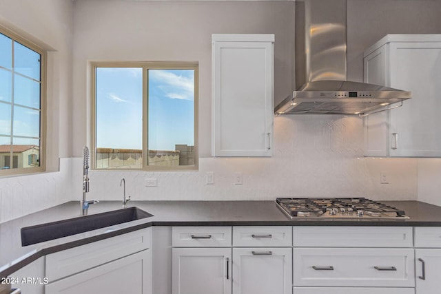 kitchen featuring white cabinetry, wall chimney exhaust hood, and stainless steel gas stovetop