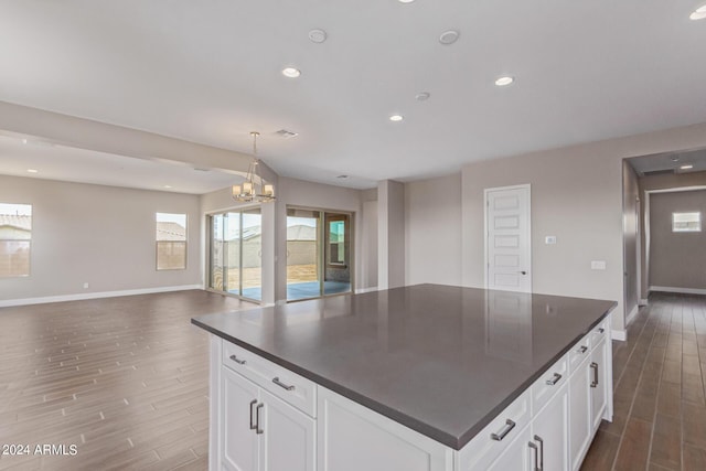 kitchen featuring dark hardwood / wood-style floors, white cabinetry, and an inviting chandelier