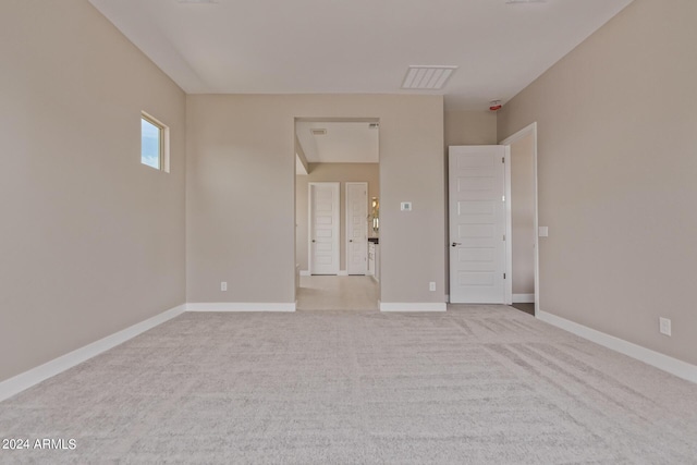 empty room featuring light carpet