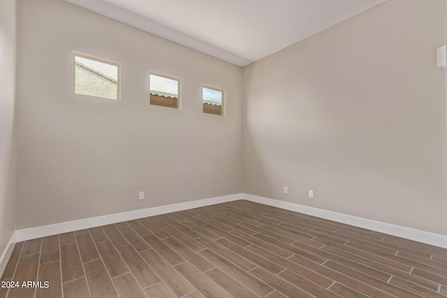 spare room featuring dark wood-type flooring