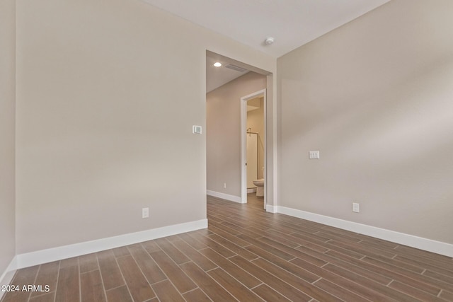 spare room featuring dark hardwood / wood-style flooring