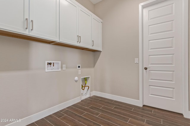 laundry area with hookup for an electric dryer, washer hookup, cabinets, dark wood-type flooring, and hookup for a gas dryer