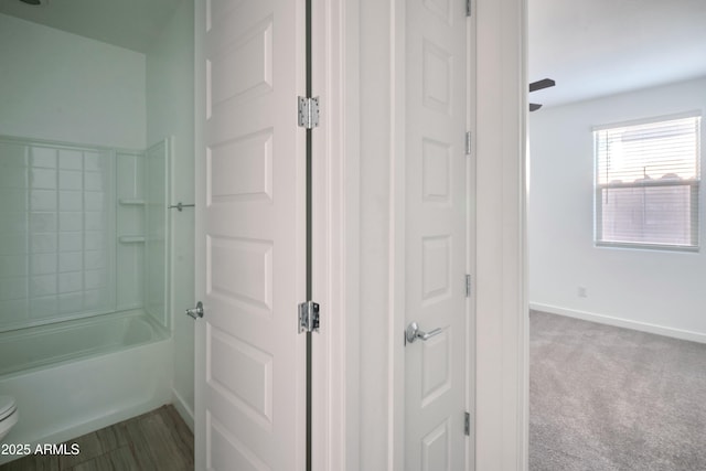 bathroom with shower / washtub combination and toilet