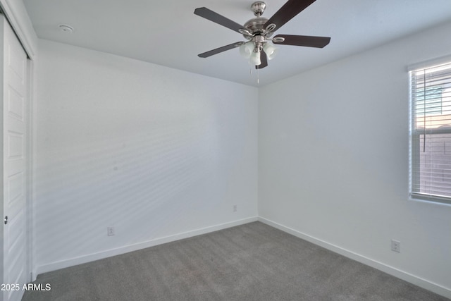 carpeted spare room with ceiling fan