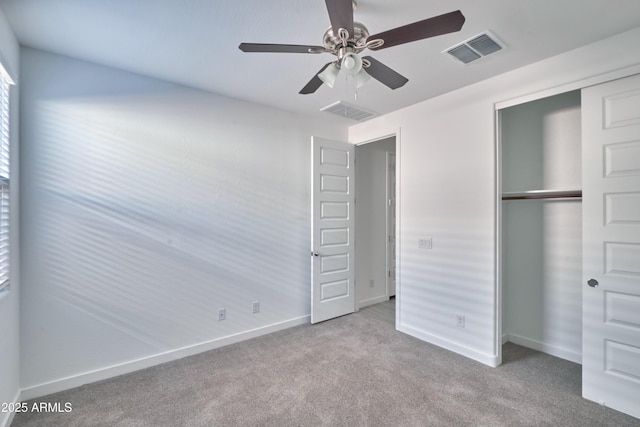 unfurnished bedroom with ceiling fan, a closet, and light carpet