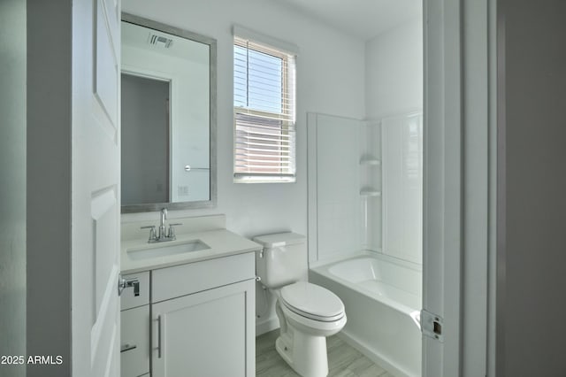 full bathroom featuring hardwood / wood-style flooring, shower / tub combination, vanity, and toilet