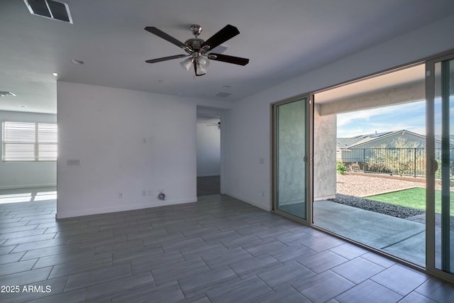 empty room with a wealth of natural light and ceiling fan