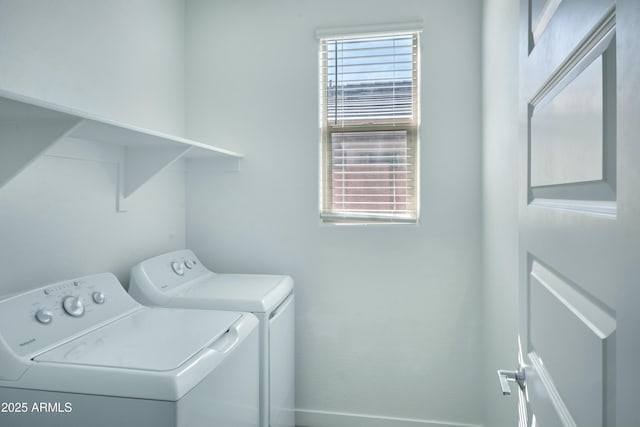 laundry room featuring a healthy amount of sunlight and washer and dryer