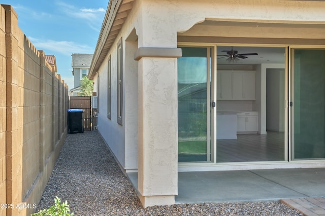 view of property exterior featuring a patio and ceiling fan