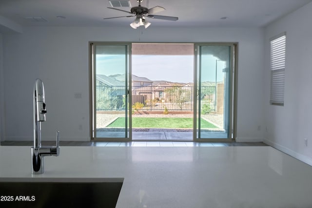 interior space with sink and ceiling fan