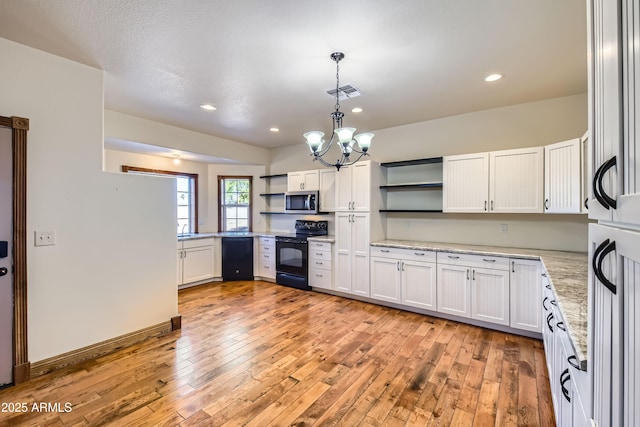 kitchen with a chandelier, white cabinetry, hanging light fixtures, and black appliances