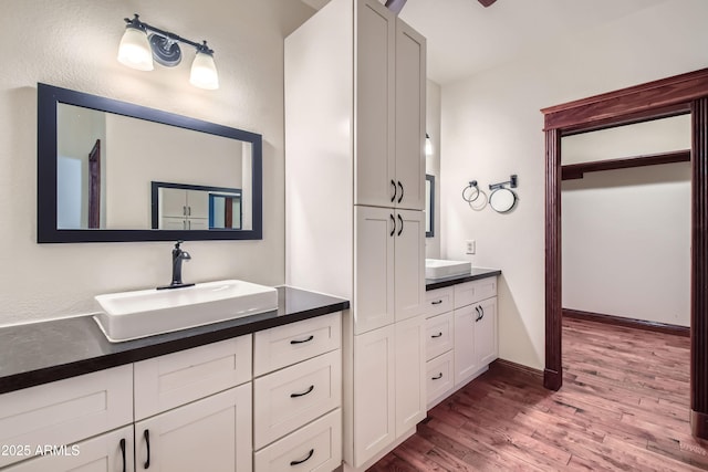 bathroom with vanity and hardwood / wood-style flooring