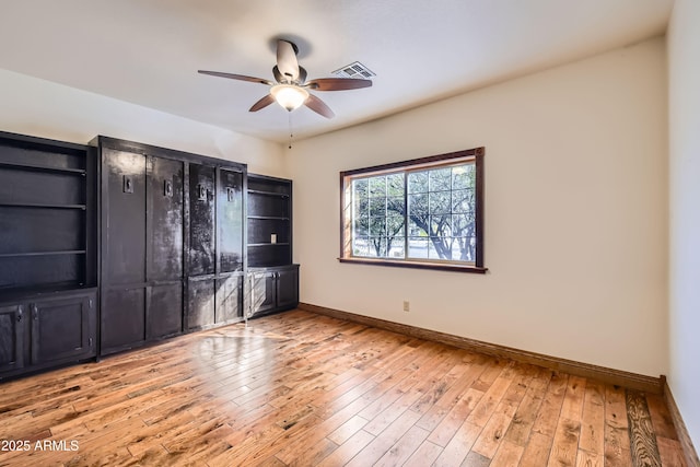 empty room featuring ceiling fan and light hardwood / wood-style flooring