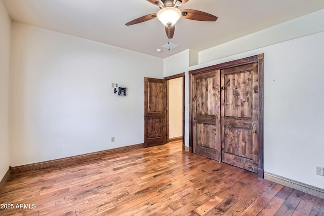 unfurnished bedroom featuring ceiling fan and hardwood / wood-style flooring