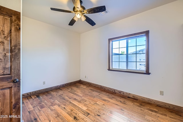 empty room featuring wood-type flooring and ceiling fan