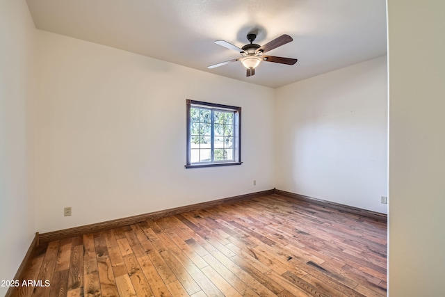 empty room with hardwood / wood-style flooring and ceiling fan