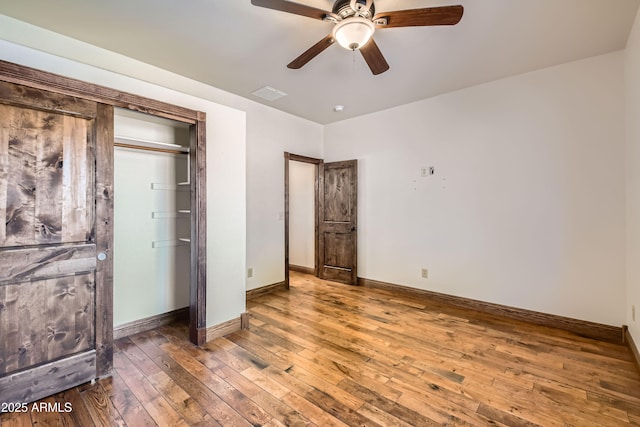 unfurnished bedroom featuring a closet, dark hardwood / wood-style floors, and ceiling fan