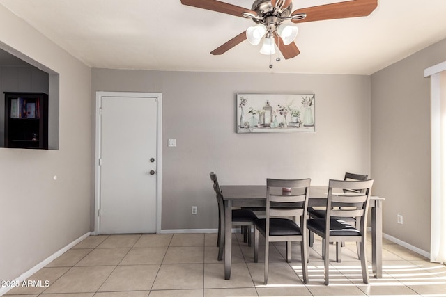 tiled dining area featuring ceiling fan