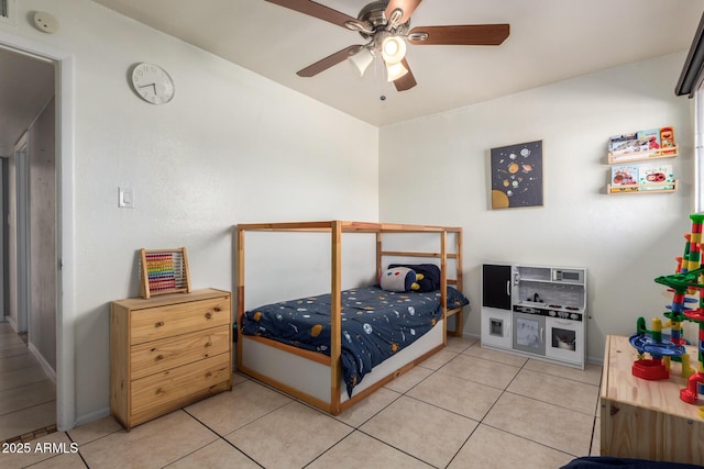 bedroom with ceiling fan and light tile patterned flooring